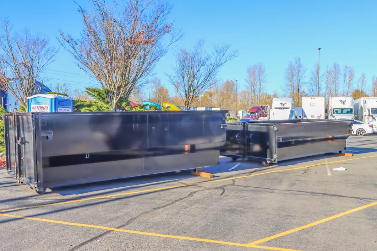 Professional dumpster rental service with roll-off container on residential driveway in Chula Vista